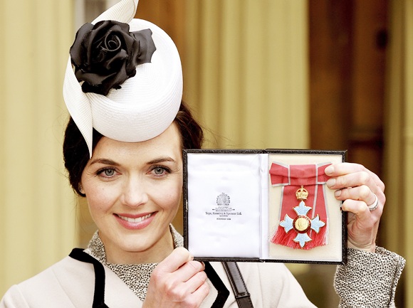 Olympic cyclist Victoria Pendleton holds her Commander of the British Empire (CBE) award at Buckingham Palace