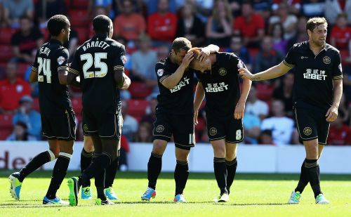 Wigan players celebrate after a goal