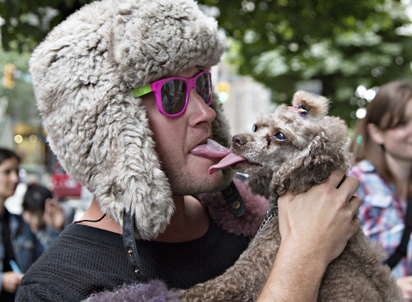 Protester Greg White kisses his pet dog Kokomo outside the Russian Consulate