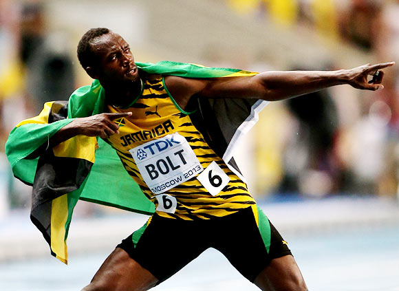 Usain Bolt celebrates after winning the men's 100m