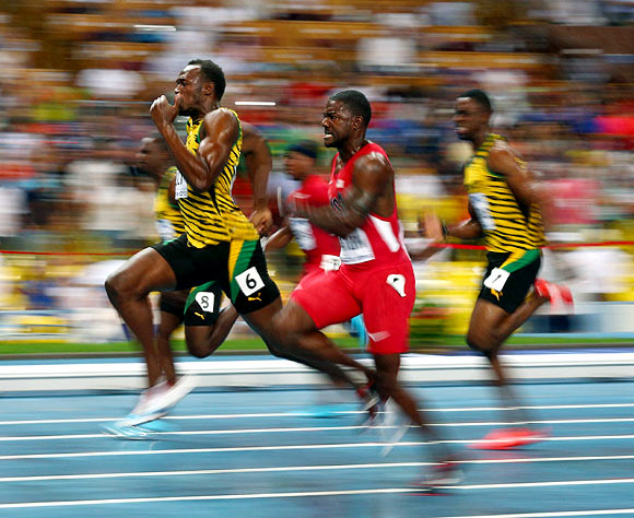 Usain Bolt (left) takes the lead in the men's 100m