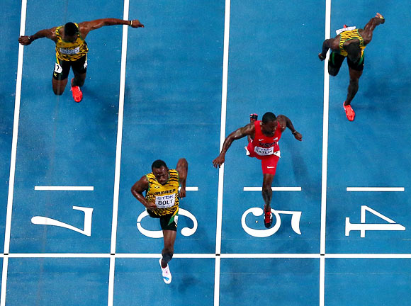 Usain Bolt (second left) wins the 100m ahead of Justin Gatlin (red) of the US