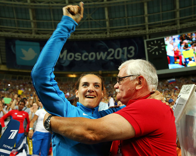 Elena Isinbaeva of Russia celebrates with her coach Evgeny Trofimov after winning gold in the Women's pole vault final on Tuesday