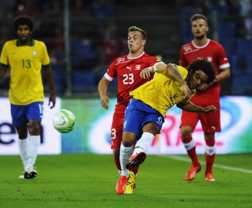 Marcelo of Brazil (R) is challenged by Xherdan Shaqiri of Switzerland during the international friendly match between Switzerland and Brazil at St. Jakob Stadium