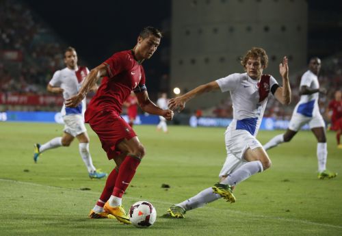 Portugal's Cristiano Ronaldo (L) controls the ball next to the Netherlands' Daley Blind during their international friendly soccer match