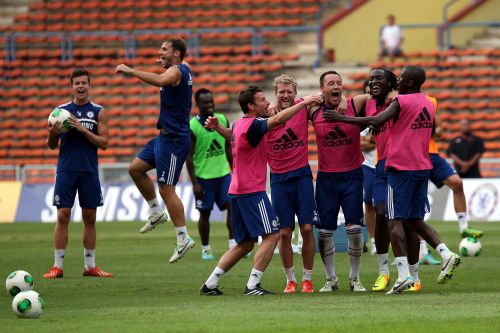 Chelsea players celebrates after Branislav Ivanovic (2nd L) scores during a Chelsea FC training session