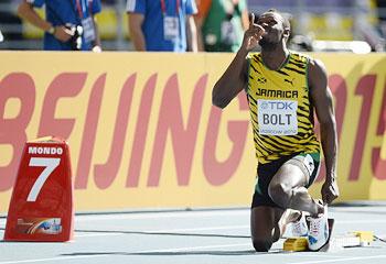 Usain Bolt of Jamaica points upwards at the starting block before his men's 200 metres heat during the IAAF World Athletics Championships at the Luzhniki stadium in Moscow on Friday