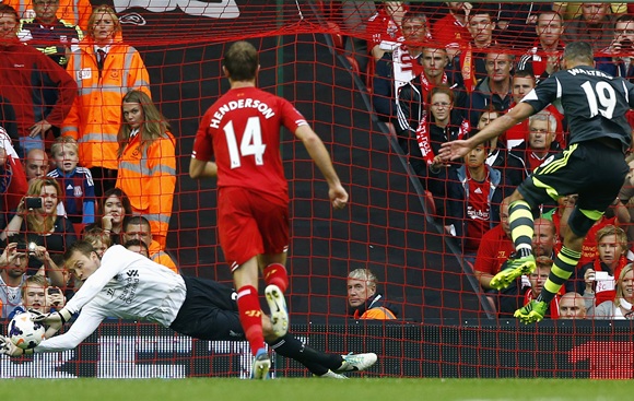 Liverpool goalkeeper Simon Mignolet saves a penalty from Stoke City's Jonathan Walters (right)