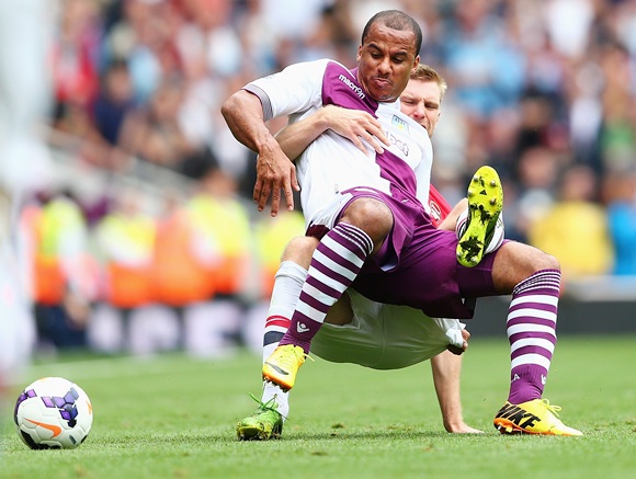 Gabriel Agbonlahor of Aston Villa is challenged by Per Mertesacker of Arsenal