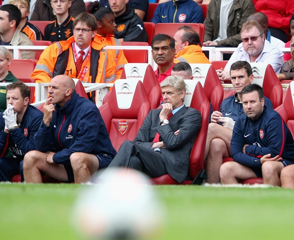 Arsenal manager Arsene Wenger (centre) is thoughtful