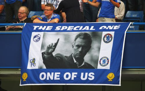 A Chelsea fan displays a banner for manager Jose Mourinho