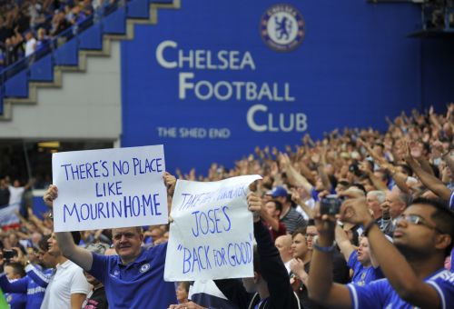 Fans hold placards supporting Chelsea's manager Jose Mourinho