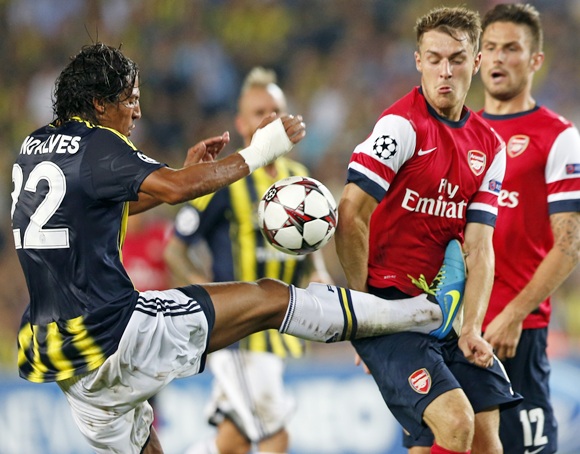Arsenal's Aaron Ramsey (right) is challenged by Fenerbahce's Bruno Alves (left)