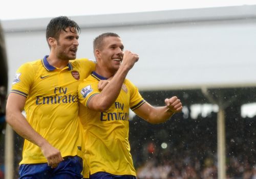 Lukas Podolski of Arsenal (R) celebrates scoring his side's third goal with team mate Olivier Giroud