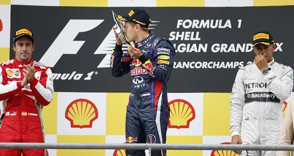 Red Bull Formula One driver Sebastian Vettel of Germany (centre) celebrates 