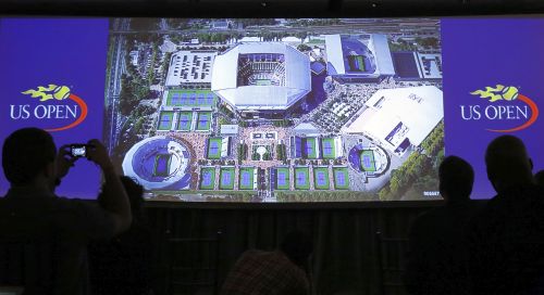 Journalists watch a video showing an artist's concept of the proposed overhaul to the United States Tennis Association (USTA) Billie Jean King National Tennis Center