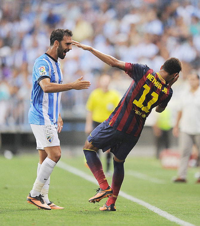 Neymar (right) of FC Barcelona reacts after being head butted by Jesus Gamez of Malaga CF during the La Liga match in Malaga, on Sunday