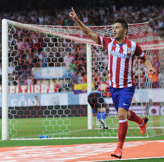 David Villa of Atletico de Madrid celebrates after scoring his team's opening goal during the Spanish Super Cup first leg match against Barcelona