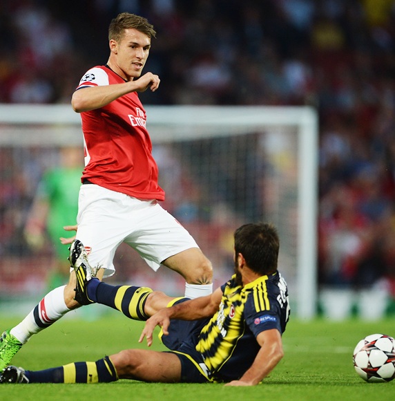Aaron Ramsey of Arsenal is challenged by Egemen Korkmaz of Fenerbahce