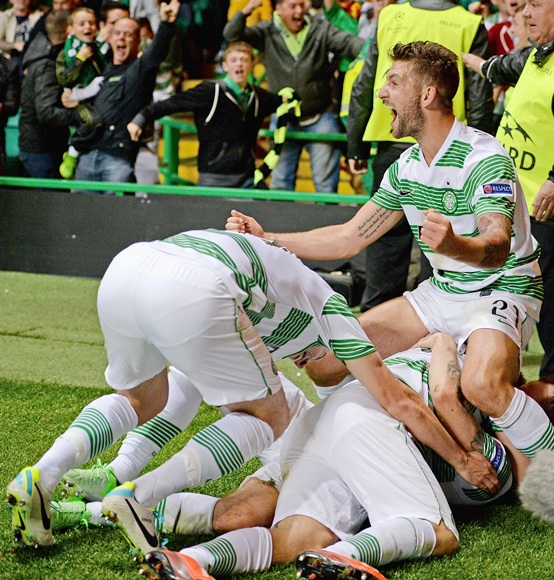 Players surround James Forrest of Celtic after he scored the winning goal