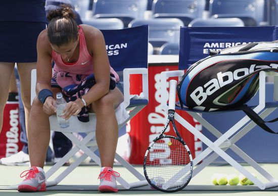Sara Errani of Italy sits during a break in play against compatriot Flavia Pennetta at the U.S. Open