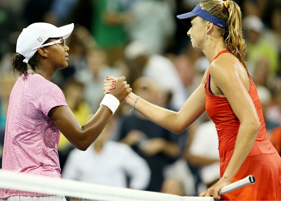 Victoria Duval shakes hands at the net with Daniela Hantuchova