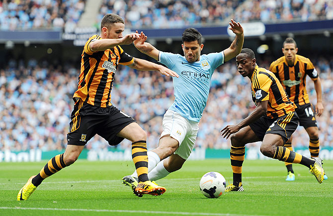 Manchester City Sergio Aguero (centre) is challenged by Hull City's Maynor Figueroa (right) and Robbie Brady during their English Premier League match on Saturday