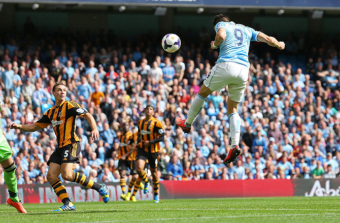 Manchester City's Alvaro Negredo heads in to score the opening goal against Hull City on Saturday