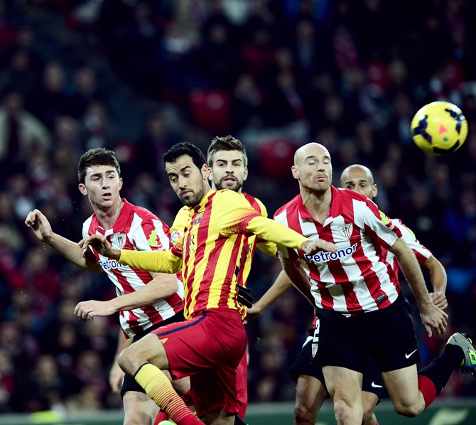 Athletic Bilbao's Aymeric Laporte (left) and Mikel Rico (right) challenge Barcelona's Cesc Fabregas (second left) and Gerard Pique