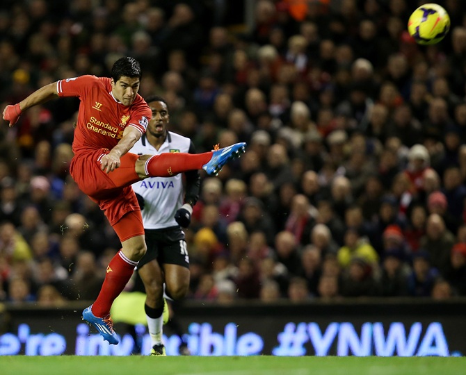 Luis Suarez of Liverpool scores his first goal