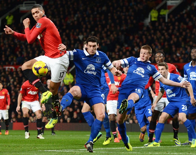 Chris Smalling of Manchester United competes with Gareth Barry of Everton