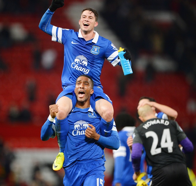 Bryan Oviedo of Everton (top) celebrates with team-mate Sylvain Distin