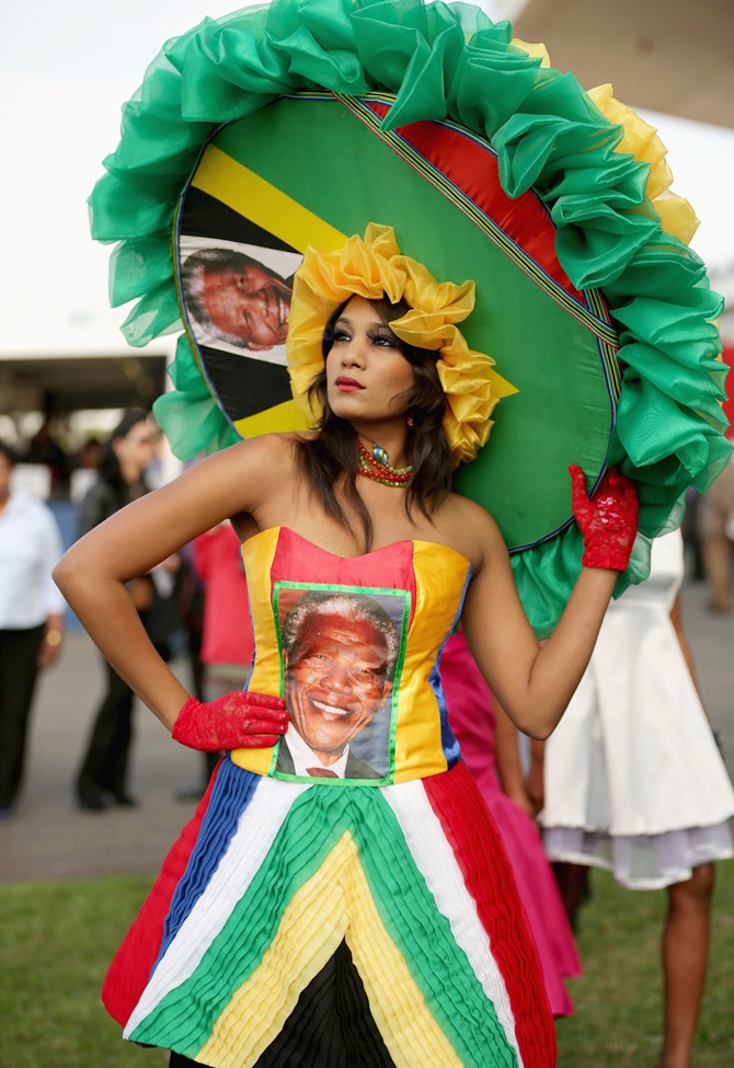 A racegoer dons a Nelson Mandela-inspired dress and hat while participating in a fashion competition