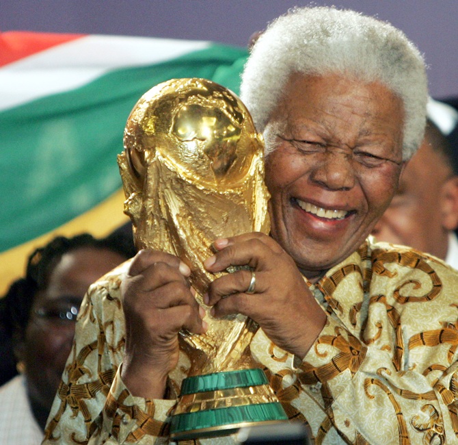 Former South African President Nelson Mandela holds the World Cup Trophy after FIFA President Joseph Blatter announced that South Africa is chosen to host the 2010 Soccer World Cup