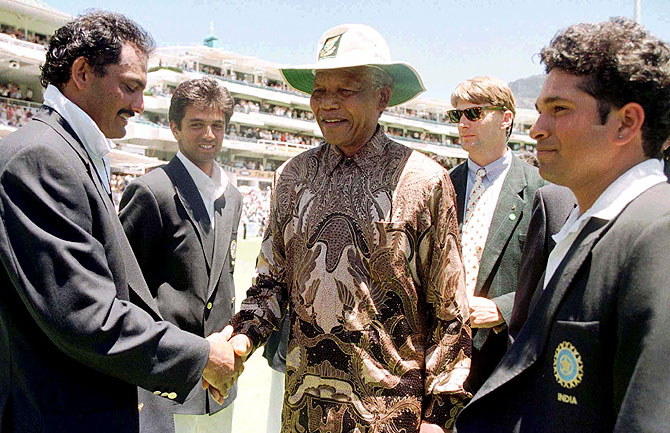 South African President Nelson Mandela (centre) is introduced to Mohammad Azharudin (left) by the Indian captain Sachin Tendulkar (right) on January 4, 1997 at the Newlands cricket ground
