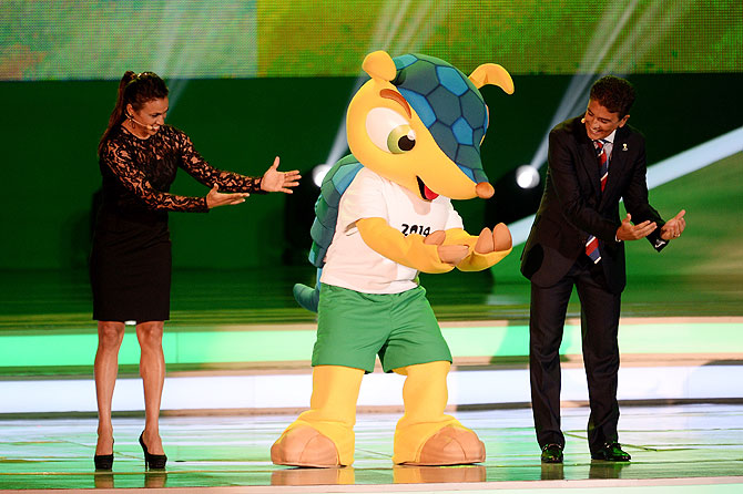 Bebeto performs his famous goal celebration with Marta and the official mascot, Fuleco on Friday