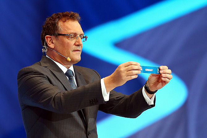 FIFA Secretary General Jerome Valcke holds up the name of Germany during the Final Draw on Friday