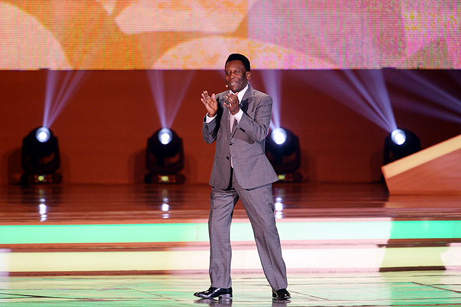 Pele applauds the audience before the draw on Friday
