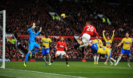 Robin van Persie of Manchester United heads over goalkeeper Tim Krul of Newcastle to score a goal that was disallowed for offside during the Barclays Premier League match between Manchester United and Newcastle United