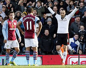 Fulham's Dimitar Berbatov (right) celebrates after scoring against Aston Villa during their English Premier League match at Craven Cottage in London, on Sunday