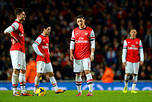 A dejected Olivier Giroud and Mesut Ozil of Arsenal prepare to restart after Gerard Deulofeu of Everton (not pictured) equalised during their English Premier League match at the Emirates Stadium in London on Sunday