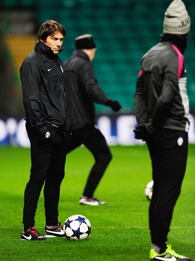 Juventus manager Antonio Conte (left) and Andrea Pirlo look on during training session
