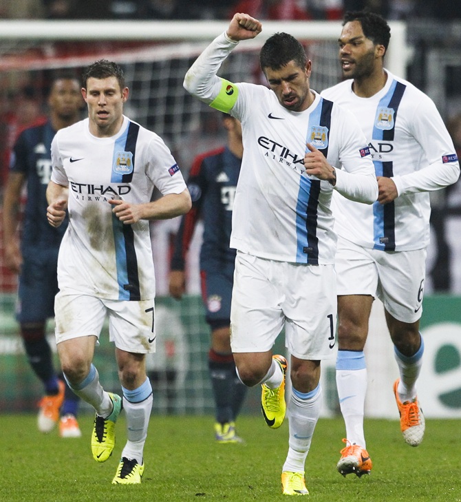 Manchester City's Aleksandar Kolarov (centre) celebrates with James Millner (left) and Joleon Lescott after scoring a goal