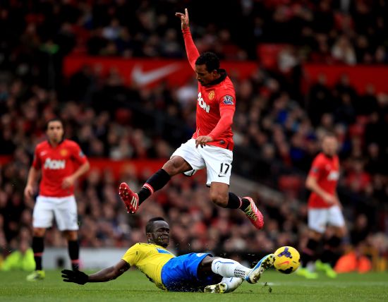 Nani of Manchester United hurrdles the tackle from Cheik Ismael Tiote of Newcastle 