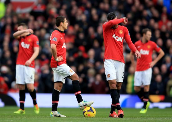 Dejected Manchester United players look on after conceding a goal