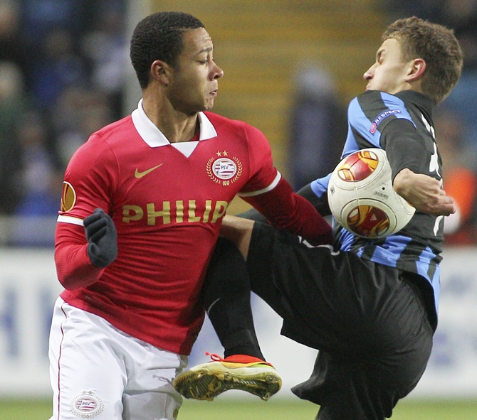 PSV Eindhoven's   Memphis Depay (left) fights for the ball with Chernomorets Odessa's Ivan Bobko