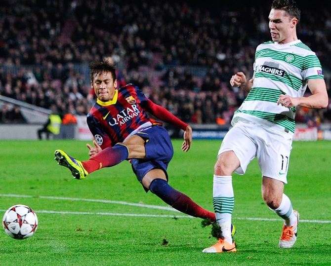 Neymar of FC Barcelona shoots towards goal under a challenge by Derk Boerrigter of Celtic