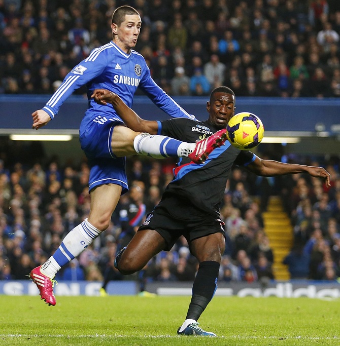 Fernando Torres of Chelsea beats Yannick Bolasie of Crystal Palace to the ball