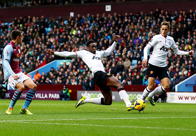 Danny Welbeck of Manchester United (centre) scores their second goal during the Barclays Premier League match against Aston Villa at Villa Park in Birmingham on Sunday