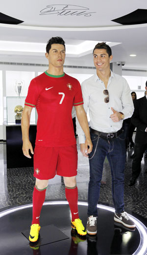 Real Madrid and Portugal's Cristiano Ronaldo, poses with his statue during the inauguration of his CR7 museum in his birthplace Funchal in Portugal on Sunday. Ronaldo opened a museum in his honour